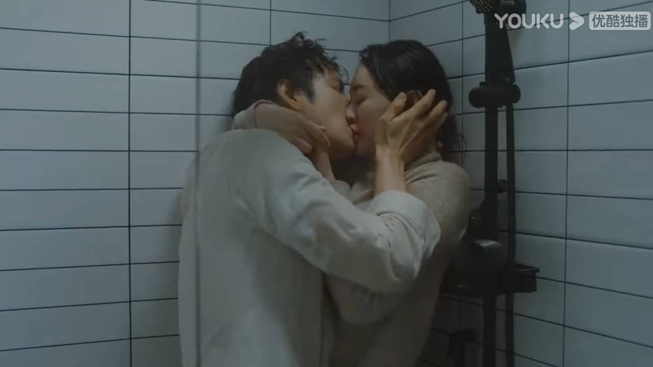 A female character and a male character are kissing under the shower.