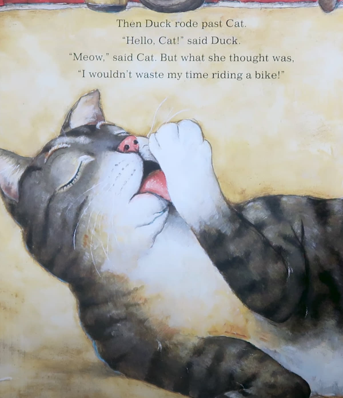 An illustration shows a large tabby cat lounging on the ground, eyes closed, calmly licking her paw. Behind her is a red barn with a tire, a shovel, and a wooden barrel. Duck is riding by on a red and white bicycle. The text reads: "Then Duck rode past Cat. ‘Hello, Cat!’ said Duck. ‘Meow,’ said Cat. But what she thought was, ‘I wouldn’t waste my time riding a bike!’"