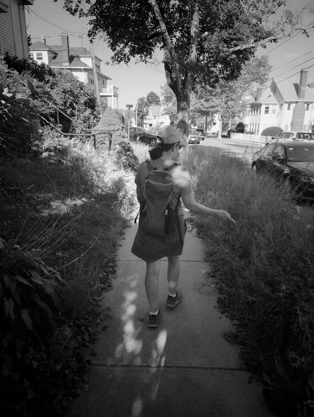 photograph of a lady on a sidewalk