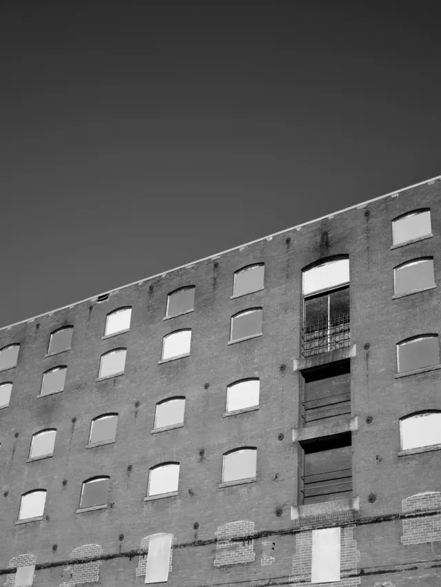 photograph of windows on an industrial brick building