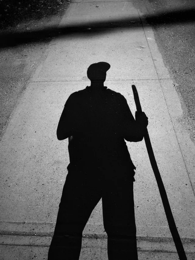 photograph of a person's shadow with a walking stick