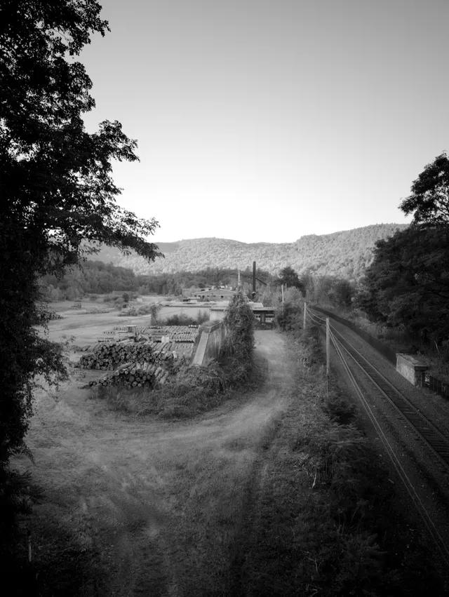 photograph of railyard and mountains