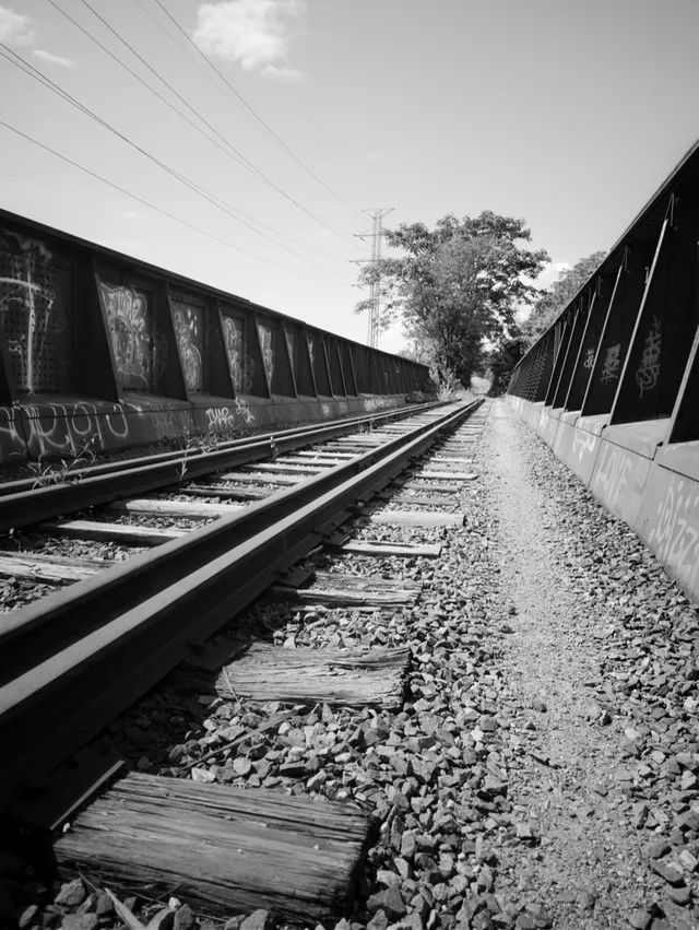 photograph of railroad track across a bridge