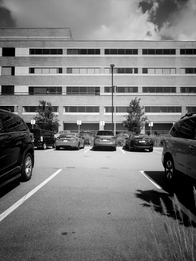 photograph of office building and parking lot